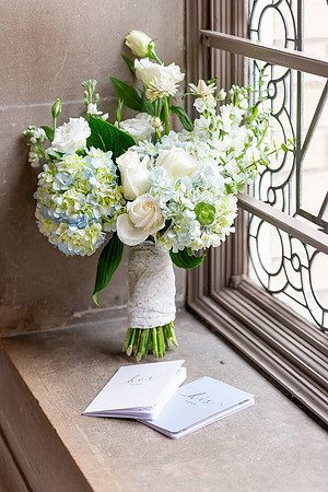 a detail photo of a bouquet and vow books at San Francisco City Hall.